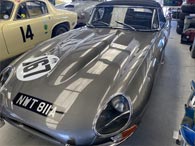 The covered headlamps of the series 1 Jaguar E-type